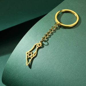 Detail of gold Israel map keychain featuring cutout Star of David on green background