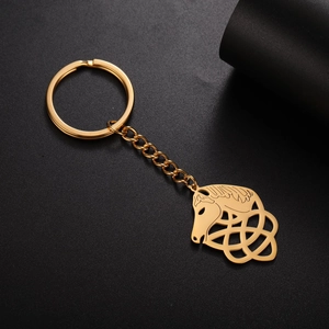 Detailed close-up of golden stainless steel horse head keychain with Celtic knot pattern