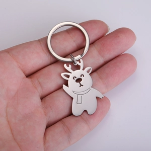 Detailed close-up of a silver stainless steel cartoon deer keychain held in hand