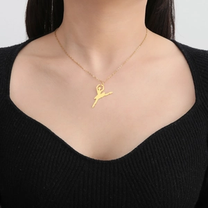 Golden stainless steel ballet dancer silhouette pendant necklace worn by a female model