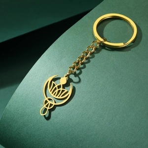 Vue détaillée du porte-clés doré avec pendentif de lotus et croissant de lune