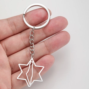 Detail view of hexagram keychain with mountain silhouette and steel chain link
