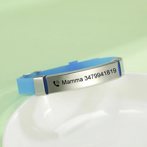Detail view of blue silicone kids ID bracelet with personalized stainless steel nameplate
