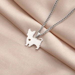 Macro detail of silver stainless steel puppy pendant with a hollow heart on champagne satin