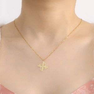 Minimalist gold stainless steel necklace with geometric windmill pendant worn by a model