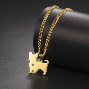Detail shot of golden terrier dog pendant with heart cutout on Cuban link chain