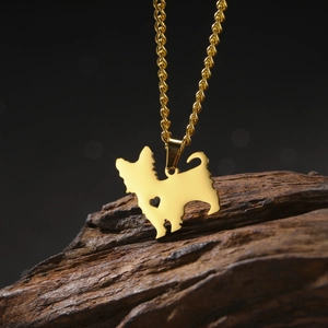 Detail of a golden chihuahua dog pendant with heart cutout on a twisted chain necklace