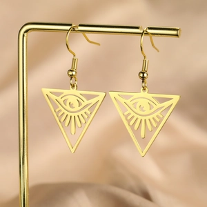 Golden stainless steel triangle earrings with eye charm on a champagne satin background