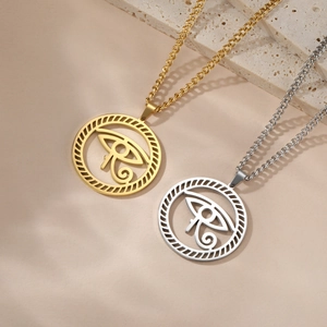 Polished stainless steel Eye of Horus necklaces in gold and silver on a stone base