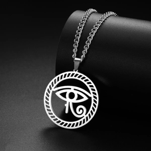 Macro shot of silver Eye of Horus pendant with intricate hollowed-out vintage details