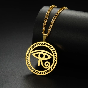 Detailed close-up of golden Eye of Horus pendant on a black textured background