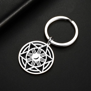 Macro detail of silver moon star stainless steel keychain on black leather background