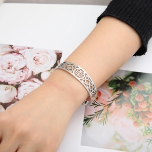 Silver geometric cut-out stainless steel cuff bracelet with Celtic knot patterns