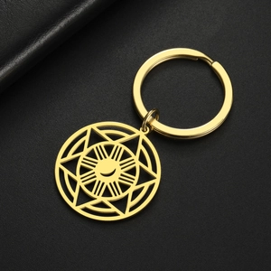 Macro shot of gold stainless steel sunburst hexagram pendant and key ring detail