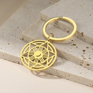 Detail of gold moon and starburst pendant on a stainless steel keychain with stone decor