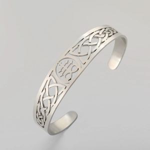 Detail of silver stainless steel cuff bracelet with Celtic knot and Leviathan cross symbol