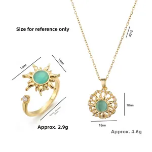 Golden rotating sunflower jewelry set with green gemstone pendant necklace and open ring