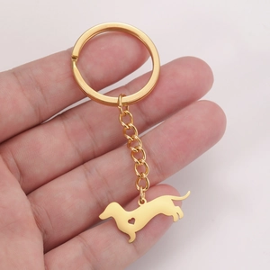 Cute golden dachshund keychain with hollow heart detail on a metal puppy pendant