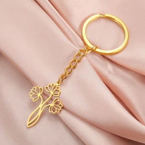 Porte-clés pendentif fleur de lotus ajouré doré en acier inoxydable sur soie