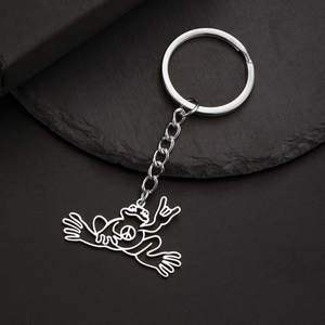 Macro detail of silver stainless steel frog pendant with peace sign on a keychain