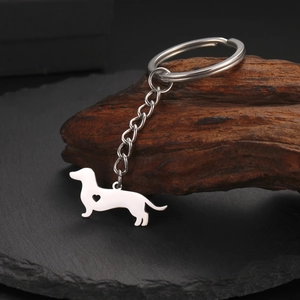 Macro shot of polished stainless steel dachshund keychain with hollow heart detail