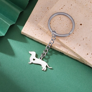 Detailed view of silver stainless steel dachshund keychain with heart cutout on stone base