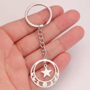 Stainless steel pentagram moon phase keychain with star charm held in palm for size