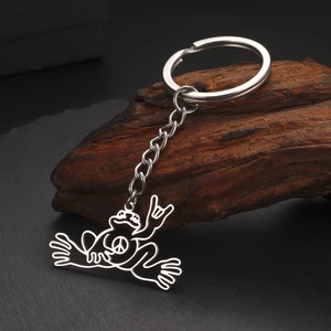 Close-up of a silver stainless steel frog pendant with a peace sign and rock-on hand gesture