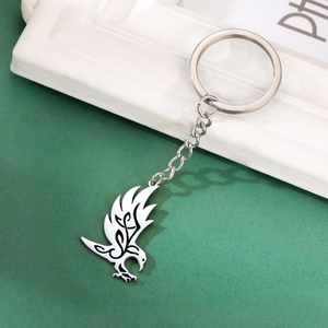 Polished stainless steel keychain featuring a hollow flying raven pendant with tribal patterns