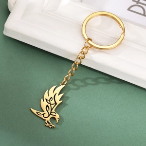 Detailed view of a golden hollowed-out eagle pendant keychain with sleek engraved lines
