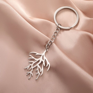 Modern stainless steel keychain with abstract coral branch pendant on satin background