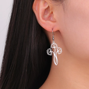 Detailed close-up of a model wearing silver stainless steel lotus drop earrings