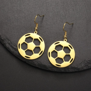 Detail of gold soccer ball dangle earrings with polished hollow design on dark stone