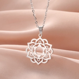 Minimalist geometric mandala flower necklace in silver stainless steel on pink satin fabric