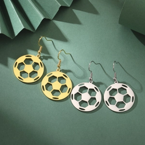 Detail of soccer ball dangle earrings in gold and silver finish with hollow-out pattern