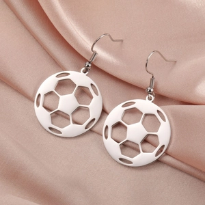 Close-up of hollow silver soccer ball dangle earrings on champagne satin background