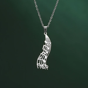 Close-up of a silver musical note pendant with artistic cut-out staff and modern finish