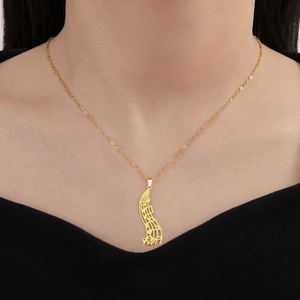 Detailed view of a gold musical note pendant with an elegant cut-out staff design
