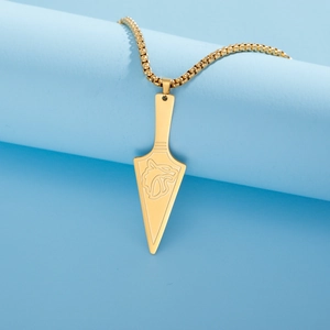 Close-up of golden stainless steel wolf arrow pendant with polished box chain