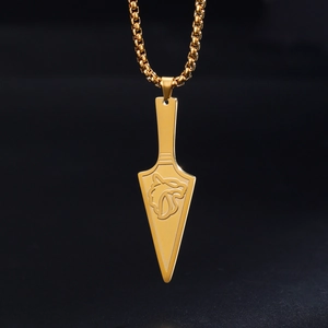 Macro shot of gold stainless steel wolf head dagger pendant with polished box chain link