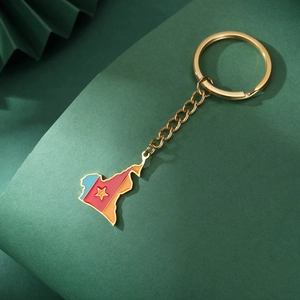 Close-up of Cameroon map keychain with colorful enamel coating and golden ring