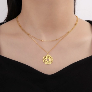 Close-up of double-layer gold necklace with a hollow mandala flower pendant on a model