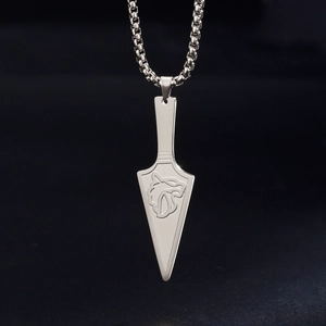 Macro detail of silver stainless steel wolf totem pendant on a sleek box chain necklace