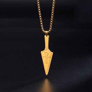 Detailed view of a gold Ankh cross arrowhead pendant with a vintage textured finish