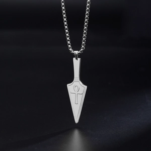 Detailed view of stainless steel arrowhead pendant necklace with engraved Ankh cross symbol