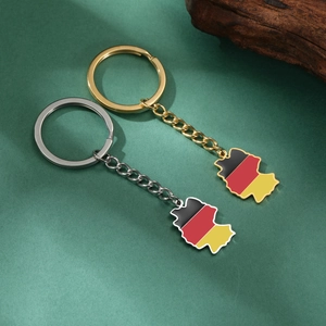 Detail of Germany map keychains in gold and silver finish with national flag colors