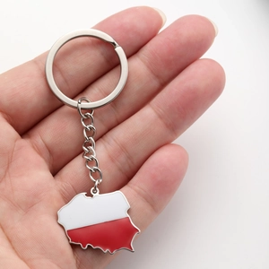 Détail du porte-clés carte de Pologne avec finition émail drapeau tenu dans la main