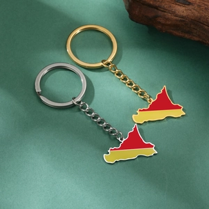 Detail of gold and silver Germany map keychains with red and yellow enamel finish