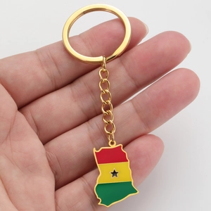 Close-up of golden Ghana map keychain with red yellow and green enamel finish