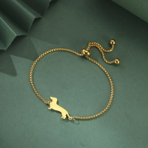 Detail of golden dachshund pendant on a box chain with an adjustable bolo clasp design